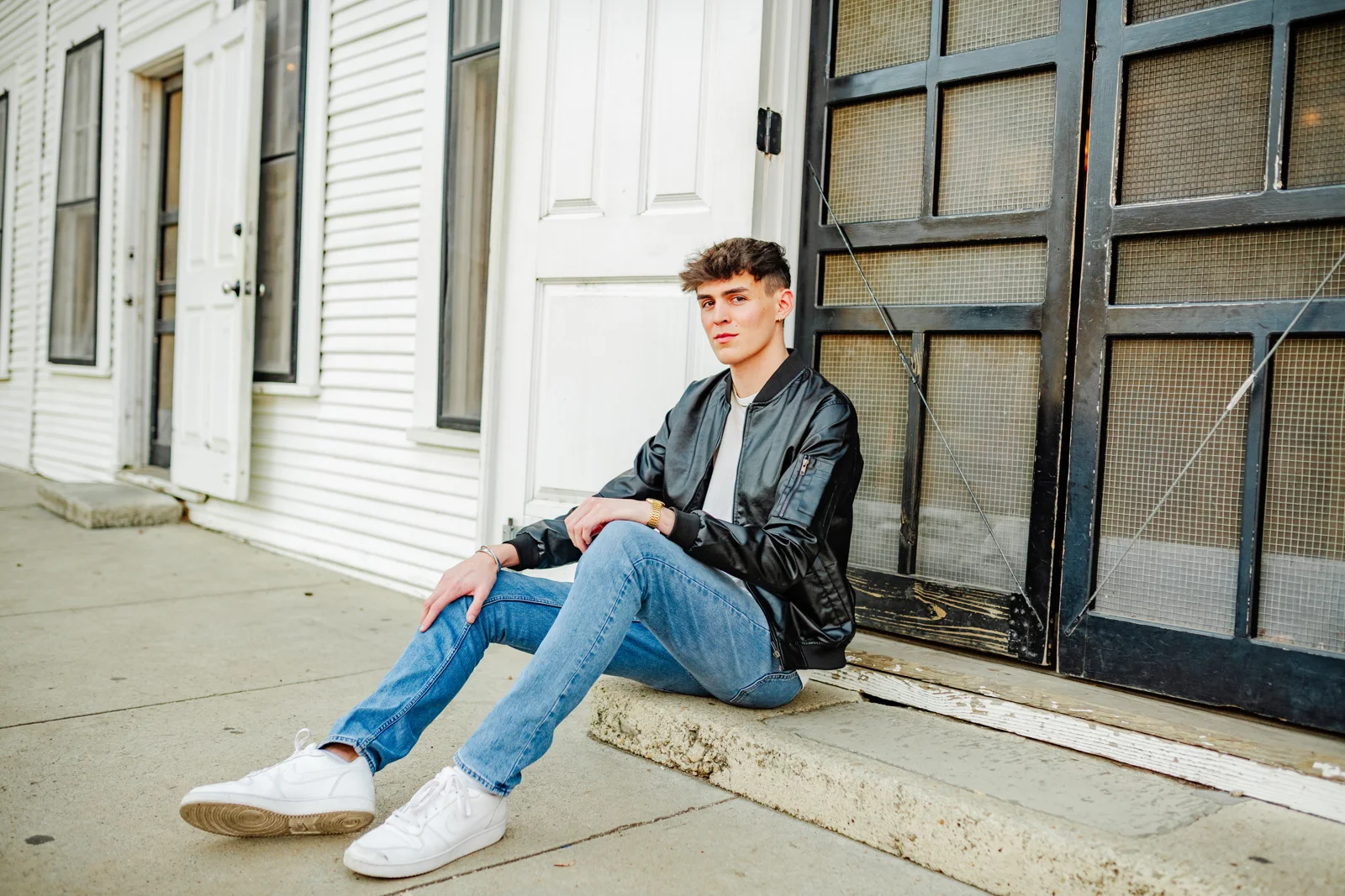 Man in the black Summit Classic Bomber sitting on courthouse steps