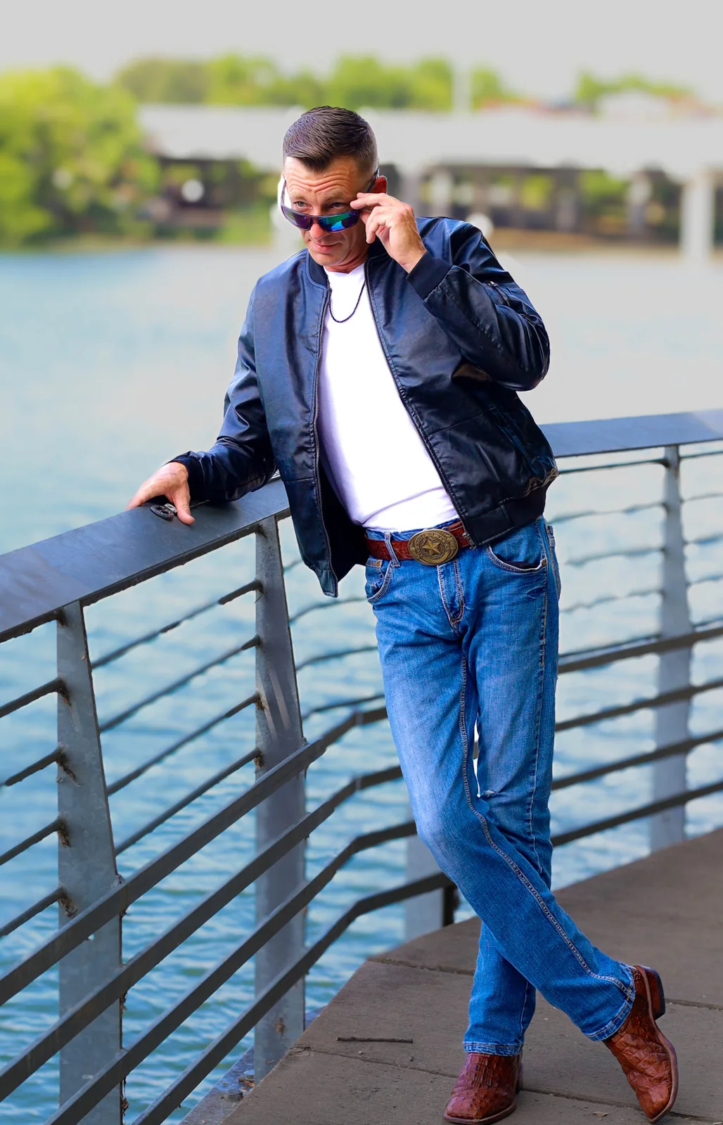 Man in the black Summit Classic Bomber with sunglasses on a bridge