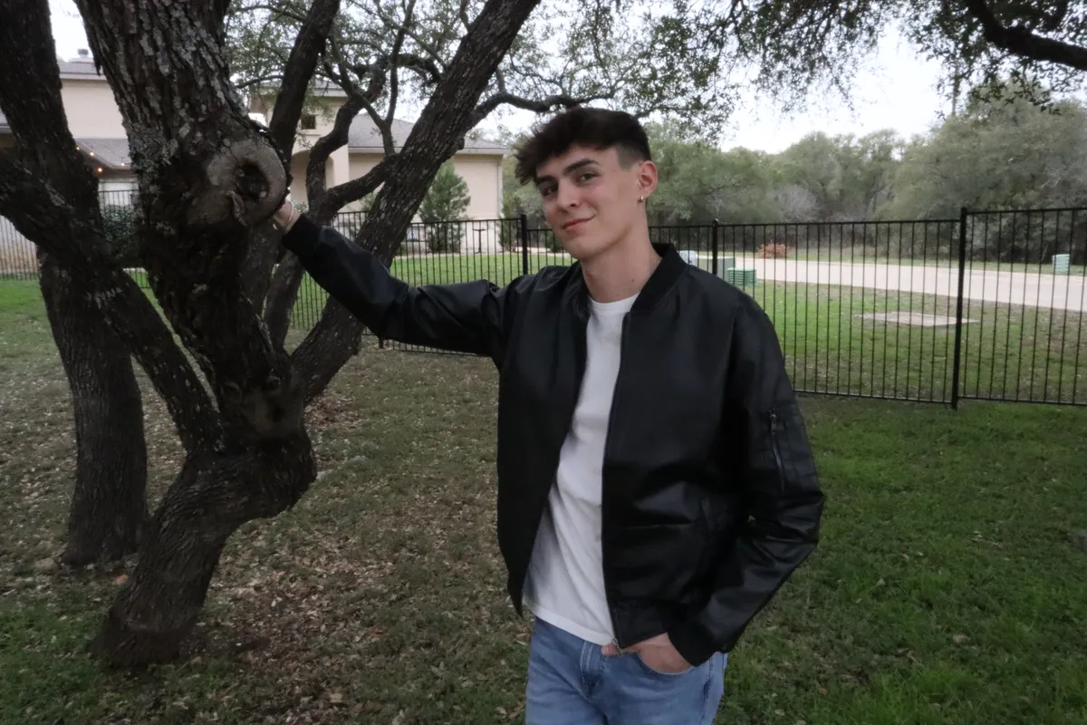 Man wearing the black Summit Classic Bomber vegan leather jacket outdoors